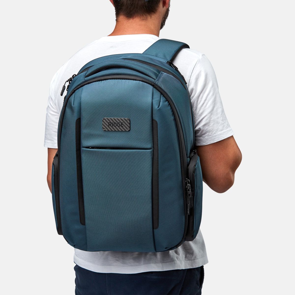 Ridge Commuter Backpack in alpine navy worn over the shoulder